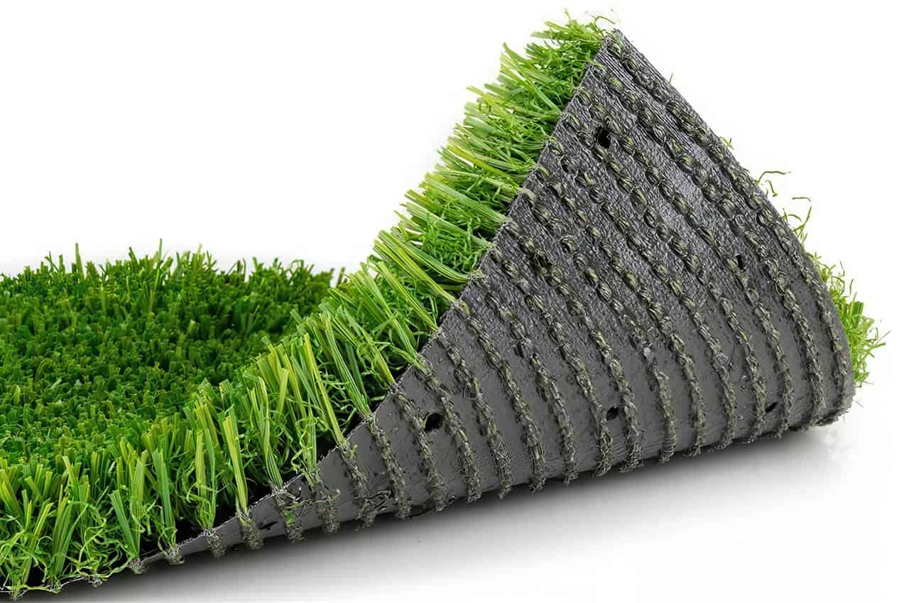 Artificial-Grass-Drainage-Backing Close-up of a rolled-up artificial grass sample showing bright green synthetic blades on a dark backing edge-to-edge view.